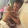 Ginger joined the competition — help win amazing prizes! child, cat, bed, blanket, plush_toy, orange_tabby, indoor, cozy, cute, soft_lighting, person, animal, cuddle, resting, comfort, sleepwear, furniture, human, pet, warm
