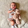 Elijah is registered to the contest to win money with this photo: baby, teddy_bear, blanket, smile, happy, infant, plush_toy, soft_texture, onesie, socks, child, cute, lying_down, cozy, comfort, portrait, indoors, young_child, person, warm