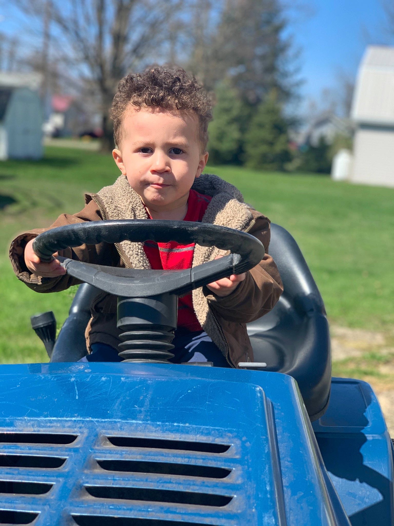 Brayson is registered to the contest to win money with this photo: auto_part, automotive_exterior, bumper, car, child, family_car, lawn, person, personal_protective_equipment, toddler, vehicle