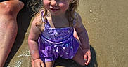 Emryn is registered to the contest to win money with this photo: adult, blonde_hair, child, dress, family, girl, outdoors, photography, ponytail, portrait, purple_outfit, reflection, sitting, smiling, summer, sunlight, swimming_pool, toddler, water, wet_surface