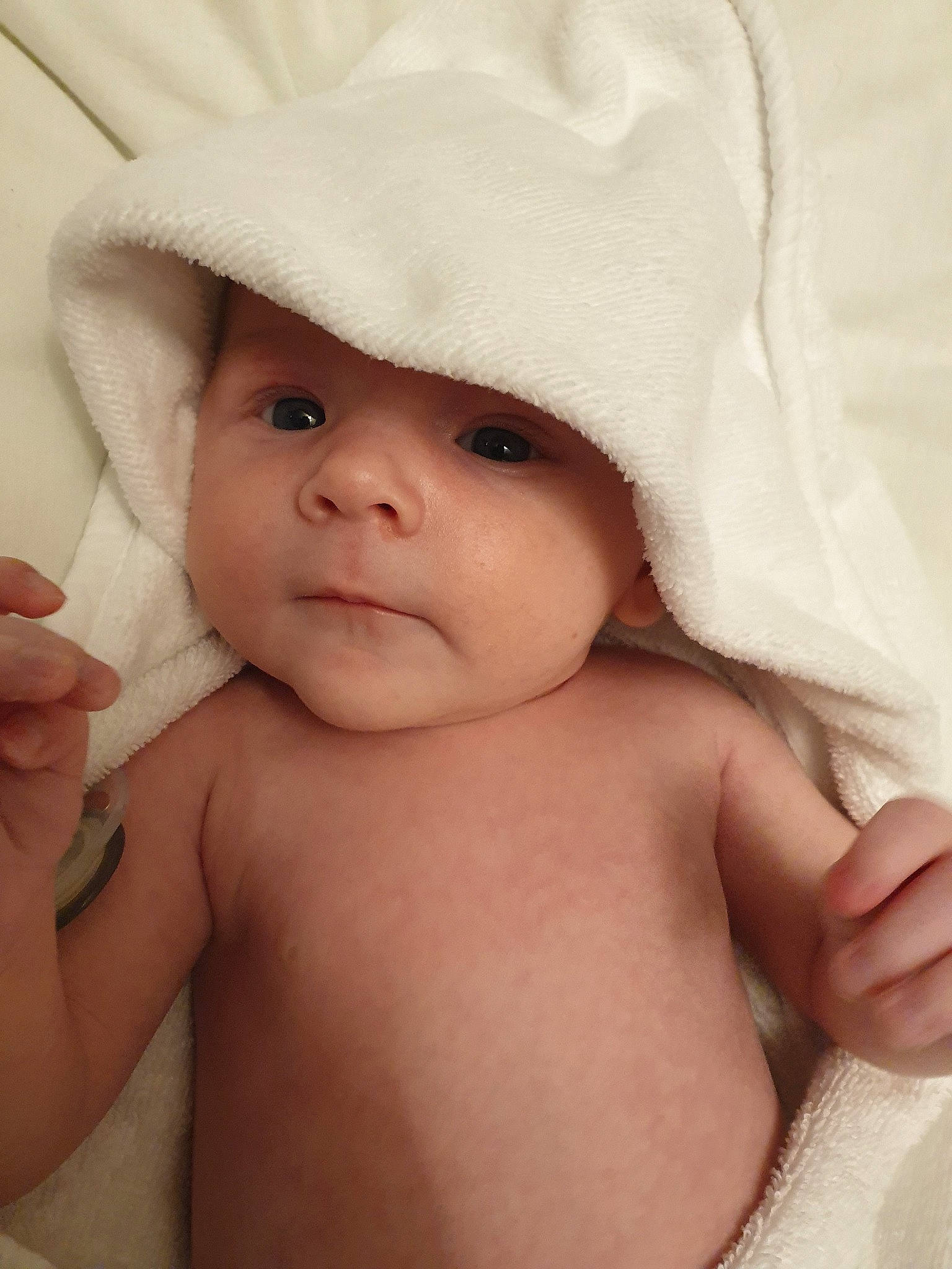 Jenson is registered to the contest to win money with this photo: baby, cheek, child, eye, face, hand, hat, headgear, headwear, linens, lip, muscle, person, skin, toddler