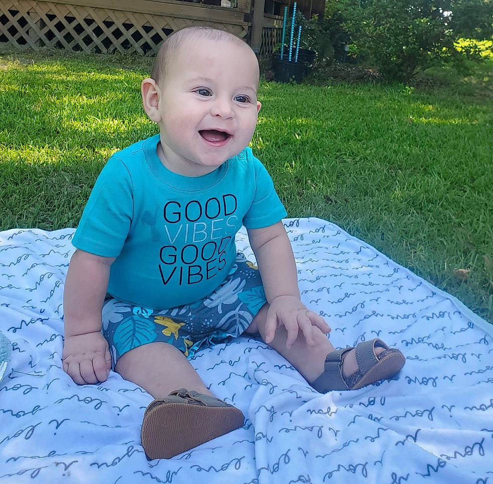 Eastyn joined the competition — help win amazing prizes! baby, baby_toddler_clothing, child, electric_blue, eye, flooring, fun, garden, grass, happy, lawn, leisure, pattern, people_in_nature, person, plant, sitting, sleeve, smile, t_shirt