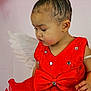 adorable, angel, bow, celebration, child, costume, curly_hair, cute, earrings, face, fashion, hair_accessory, indoors, pink_background, portrait, red_dress, sequins, small_child, toddler, wings
