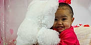 Kaioni is registered to the contest to win money with this photo: baby, balloons, celebration, child, cute, decorations, flower_accessory, happy, headband, hugging, indoor, joyful, pink_clothing, plush, portrait, smiling, soft_toys, stuffed_animal, teddy_bear, toddler