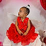 Kaioni joined the competition — help win amazing prizes! adorable, angel_wings, baby, balloon, celebration, child, costume, curious, cute, decor, festive, fluffy, heart, holiday, indoor, portrait, red_dress, sitting, toddler, white_blanket