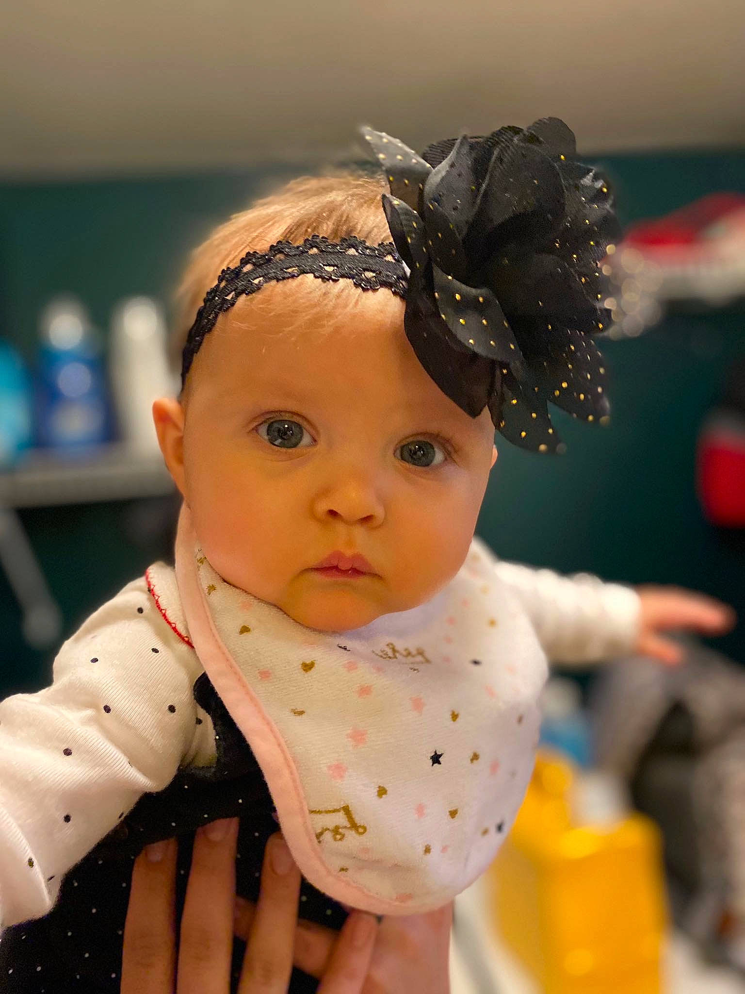 Emmerson is registered to the contest to win money with this photo: baby, cheek, child, doll, ear, fashion_accessory, forehead, hair_accessory, head, headband, headgear, headpiece, person, room, toddler, toy