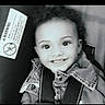 Heavenly joined the competition — help win amazing prizes! child, toddler, smiling, car_seat, denim_jacket, curly_hair, black_and_white, portrait, happy, seatbelt, warning_label, indoor, young_child, cute, face, person, clothing, safety, baby, closeup