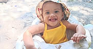 Heavenly is registered to the contest to win money with this photo: baby, child, smiling, hat, yellow_outfit, baby_walker, outdoor, sunlight, grass, pool, playground, happy, infant, summer, seat, person, cute, nature, fun, toddler