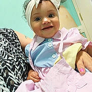 Heavenly joined the competition — help win amazing prizes! baby, child, smile, headband, bow, dress, striped_clothing, indoor, person, hand, patterned_clothing, happy, curly_hair, holding, fingernails, door, wall, portrait, cute, infant