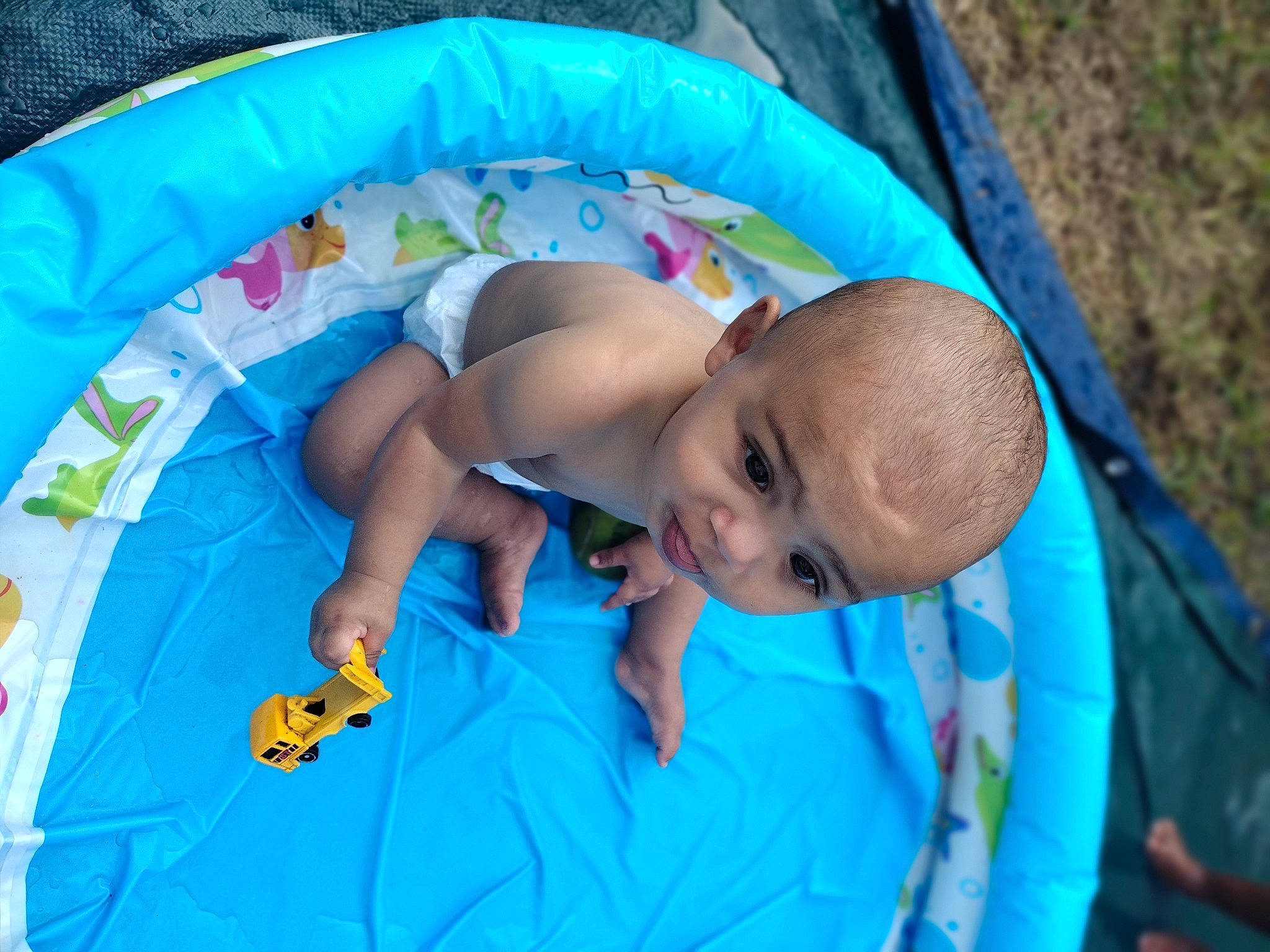 Delonta is registered to the contest to win money with this photo: baby, baby_products, baby_safety, baby_toddler_clothing, baby_toys, child, comfort, electric_blue, fun, grass, happy, infant_bed, leisure, linens, person, play, recreation, sitting, toddler, vacation
