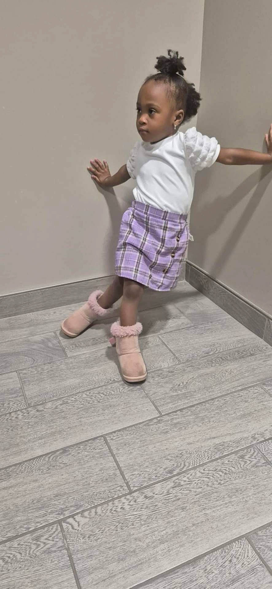 Safiya is registered to the contest to win money with this photo: child, clothing, dancing, face, female, footwear, girl, happy, head, leisureactivities, pants, person, photography, portrait, shoe, shorts, sitting, skirt, sleeve, sneaker