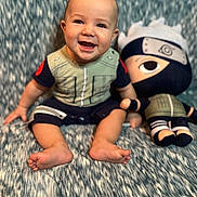 Jasper joined the competition — help win amazing prizes! baby, blanket, blue_eyes, child, costume, cute, fabric, face, feet, hand, happy, indoors, ninja, plush_toy, portrait, short_hair, sitting, smiling, soft_toy, toy