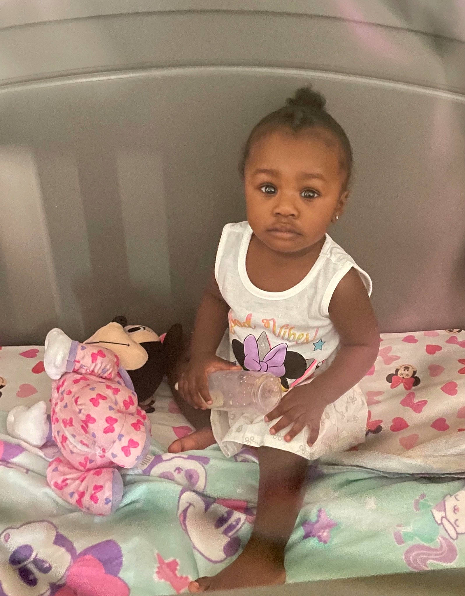 Asia is registered to the contest to win money with this photo: baby, baby_products, baby_toddler_clothing, cheek, child, comfort, eye, fun, happy, human_body, linens, magenta, pattern, person, pink, sitting, skin, sleeve, sock, toddler