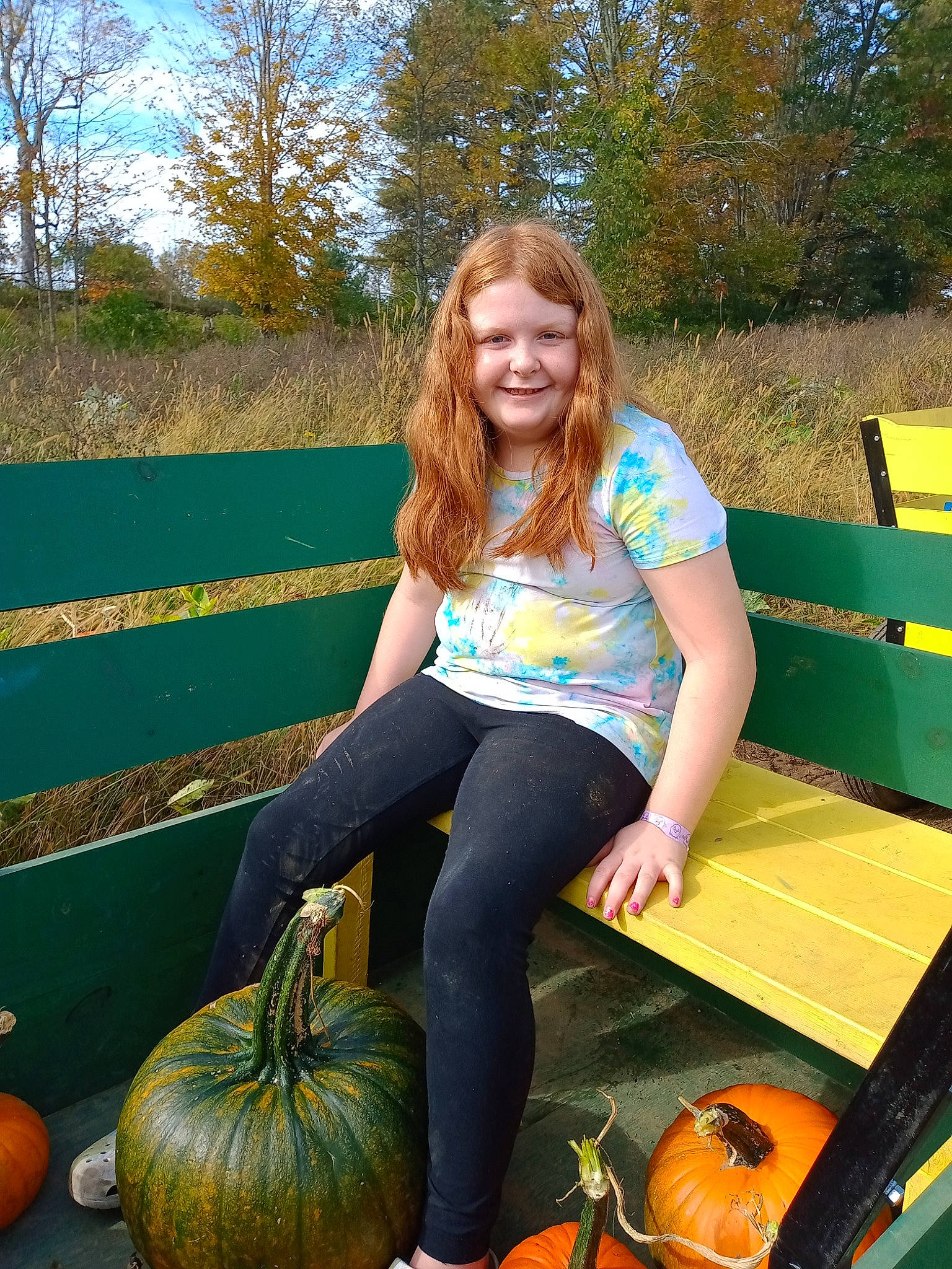Lillianna joined the competition — help win amazing prizes! calabaza, cucurbita, gourd, grass, green, happy, joy, leg, leisure, natural_foods, people_in_nature, person, photograph, plant, pumpkin, sky, smile, squash, thigh, tree