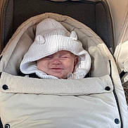 Ronnie-Lee joined the competition — help win amazing prizes! baby, child, stroller, white, hood, knitted, smile, face, cozy, warm, outdoor, infant, cute, clothing, button, fabric, soft, nap, rest, ears
