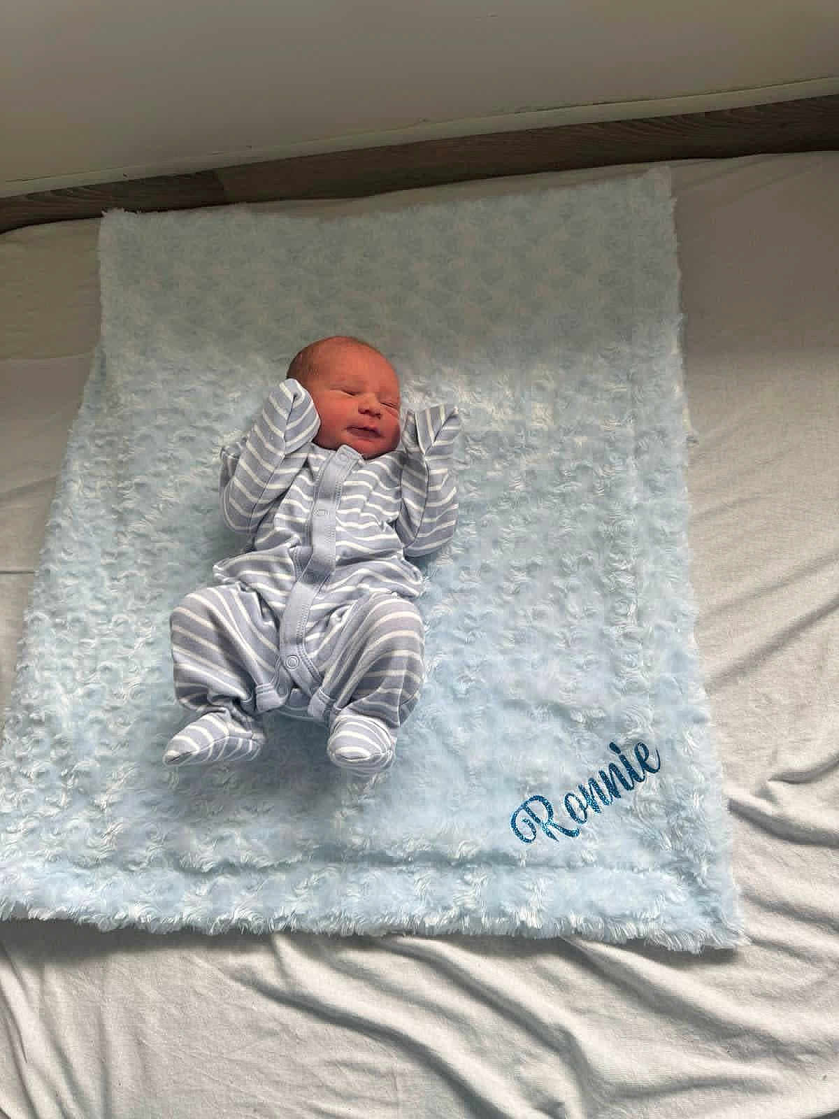 Ronnie-Lee is registered to the contest to win money with this photo: newborn, baby, infant, striped_onesie, blanket, soft_texture, bed, sleeping, peaceful, cute, small_hands, cozy, fabric, light_blue, white, resting, portrait, indoors, child, sleep