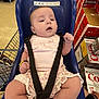 aisle, baby, blue_seat, bracelet, cart, child, cute, cute_baby, diet_coke, floor, grocery_store, infant, person, pink_clothing, retail, shopping, shopping_cart, soda_boxes, store, straps