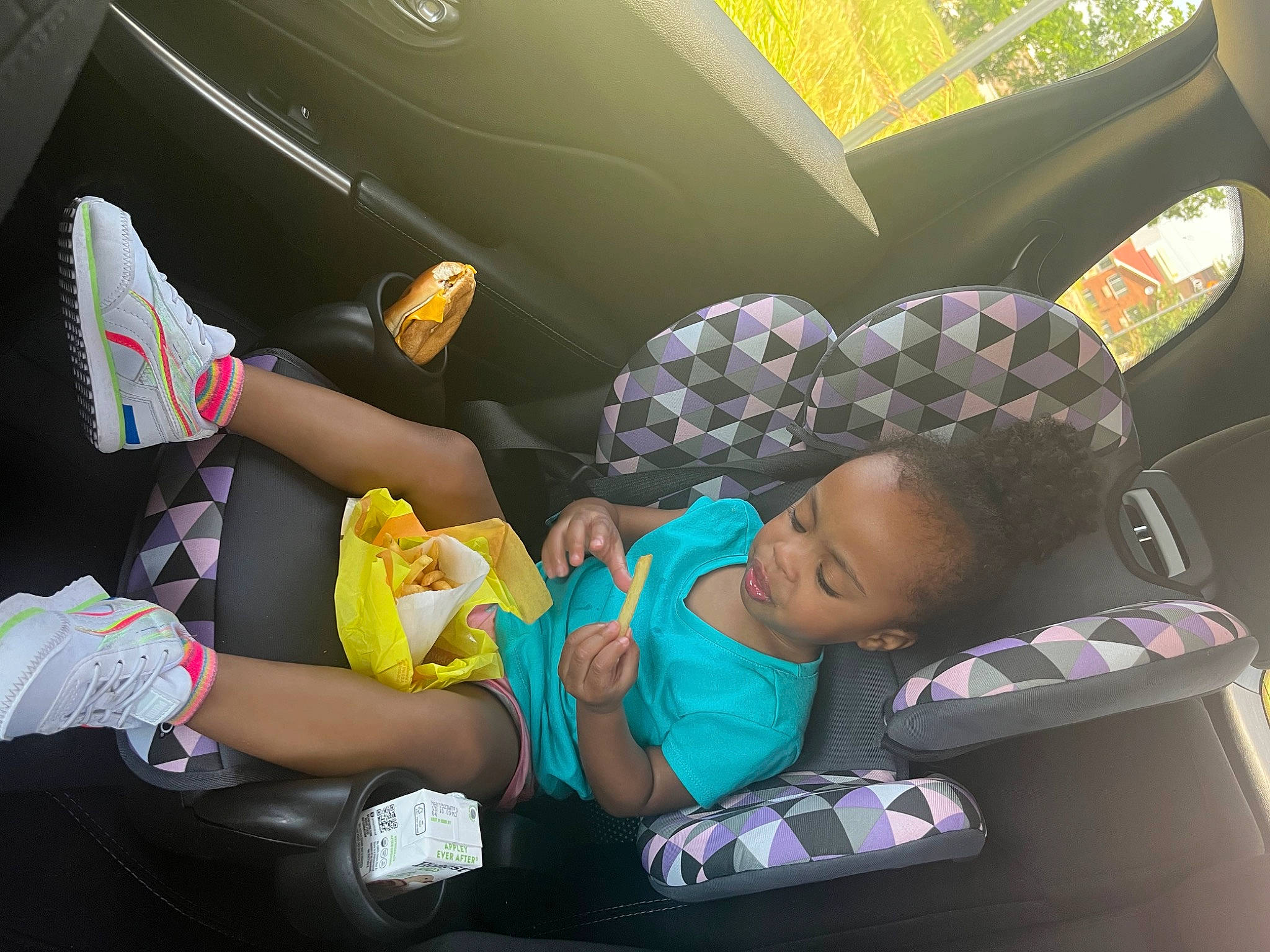 Maleah is registered to the contest to win money with this photo: auto_part, automotive_design, automotive_exterior, baby_carriage, baby_in_car_seat, baby_products, car_seat, car_seat_cover, comfort, family_car, head_restraint, lap, leisure, motor_vehicle, passenger, person, sitting, toddler, tree, trunk