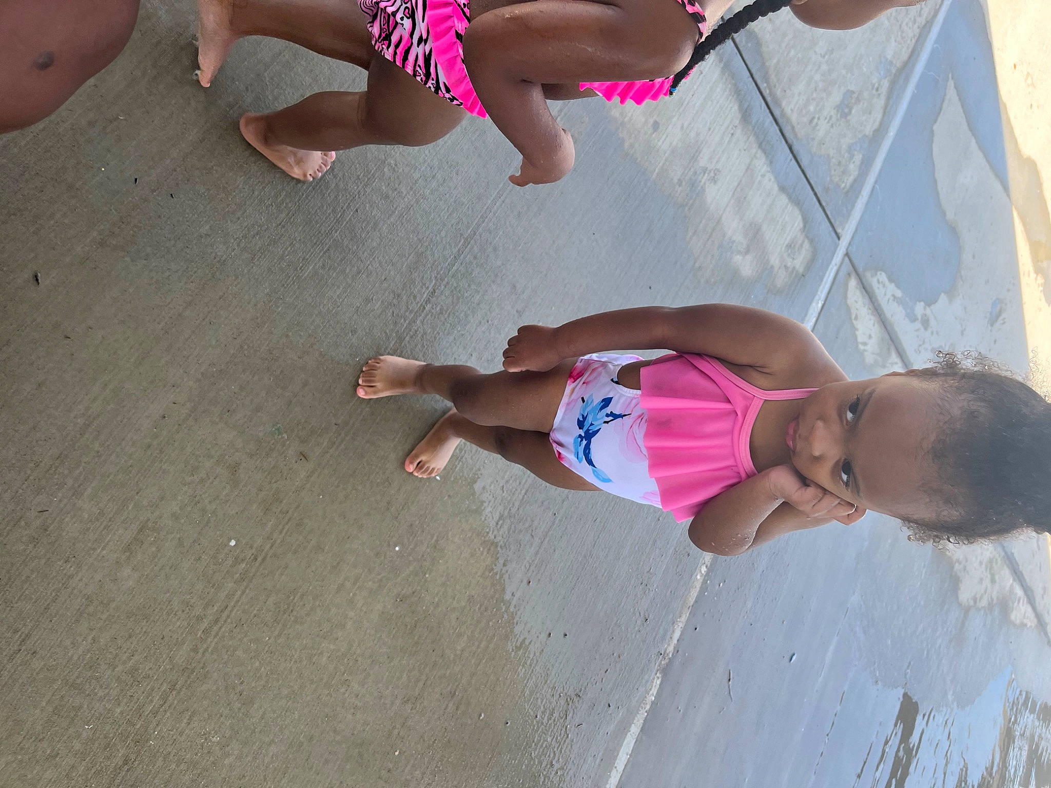 Maleah is registered to the contest to win money with this photo: barefoot, beach, calf, elbow, foot, fun, happy, human_leg, joint, knee, leg, leisure, person, pink, recreation, shorts, summer, swimwear, thigh, toddler