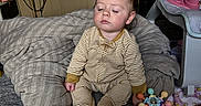 Jasmine joined the competition — help win amazing prizes! baby, child, infant, sleepy, sitting, striped_pajamas, onesie, blanket, bed, nursery, playroom, toys, rattle, stuffed_animal, television, indoors, portrait, face, dark_hair, date_stamp