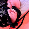 Jasmine joined the competition — help win amazing prizes! baby, infant, foot, toes, sole, blanket, fabric, patterned_clothing, pink, red, black, closeup, indoor, bed, soft_lighting, date_stamp, sleeping, cozy, portrait, family_photo