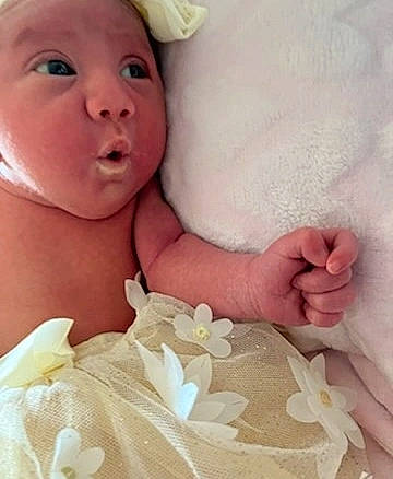 Amelia joined the competition — help win amazing prizes! baby, baby_sleeping, baby_toddler_clothing, child, comfort, eyelash, finger, gesture, happy, linens, lip, nail, pattern, person, petal, pink, product, skin, textile, toddler