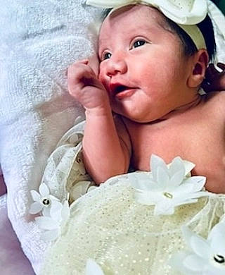 Amelia joined the competition — help win amazing prizes! baby, cap, child, eye, eyebrow, eyelash, face, happy, headgear, headpiece, iris, lip, person, petal, pink, product, skin, smile, textile, toddler