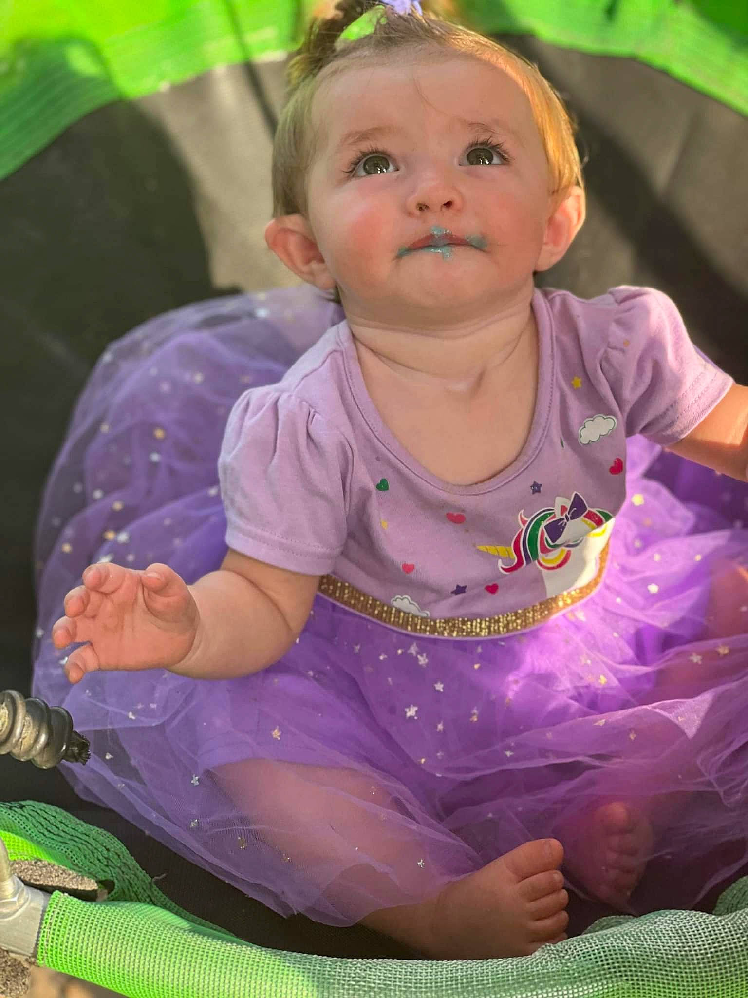 Olivia is registered to the contest to win money with this photo: baby, baby_toddler_clothing, beauty, cheek, child, facial_expression, fun, grass, green, happy, leisure, magenta, organ, person, pink, purple, recreation, sitting, skin, toddler