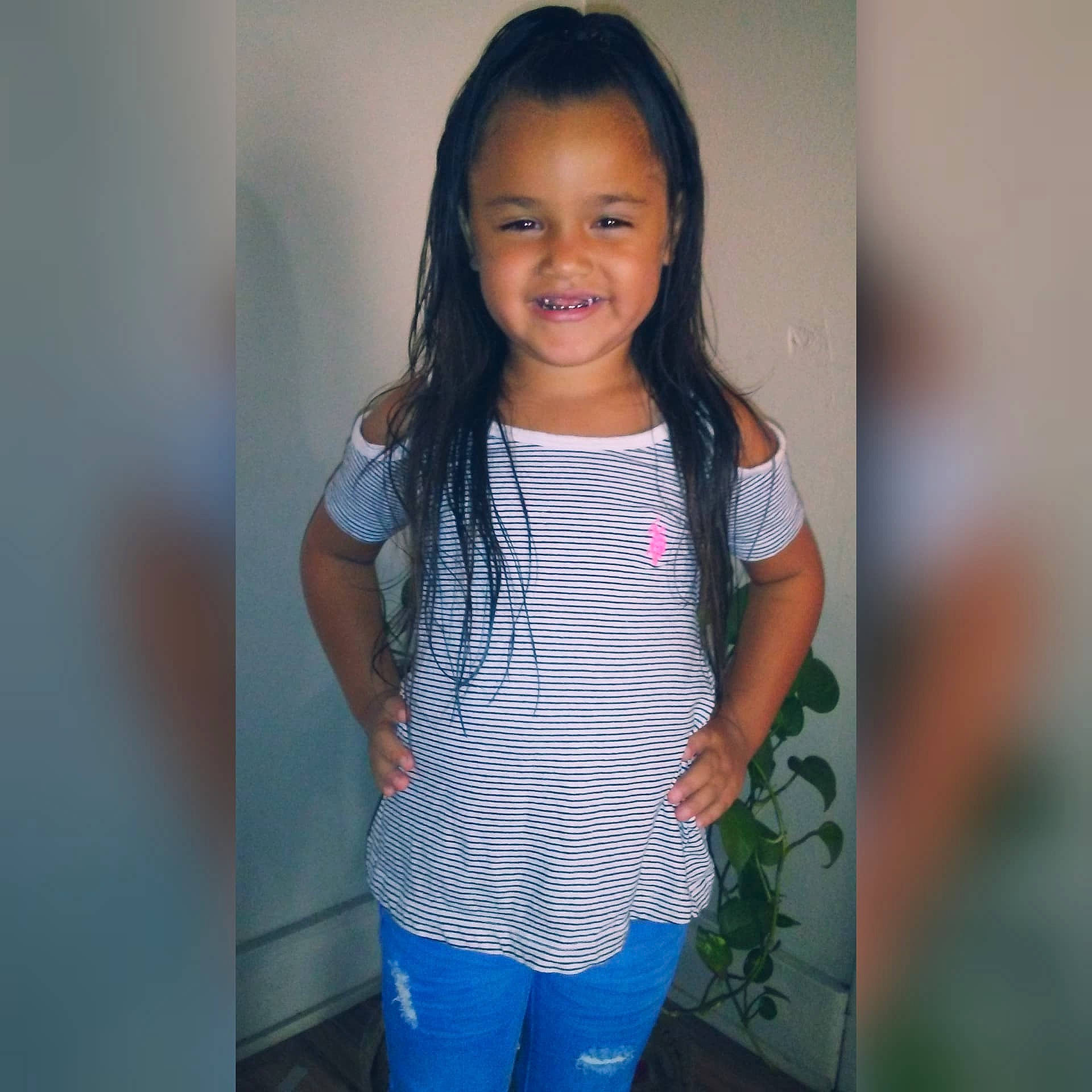 Josie is registered to the contest to win money with this photo: black_hair, child, child_model, clothing, cool, day, girl, hair, hairstyle, human_hair_color, jeans, joy, long_hair, outerwear, person, product, shoulder, smile, standing, t_shirt