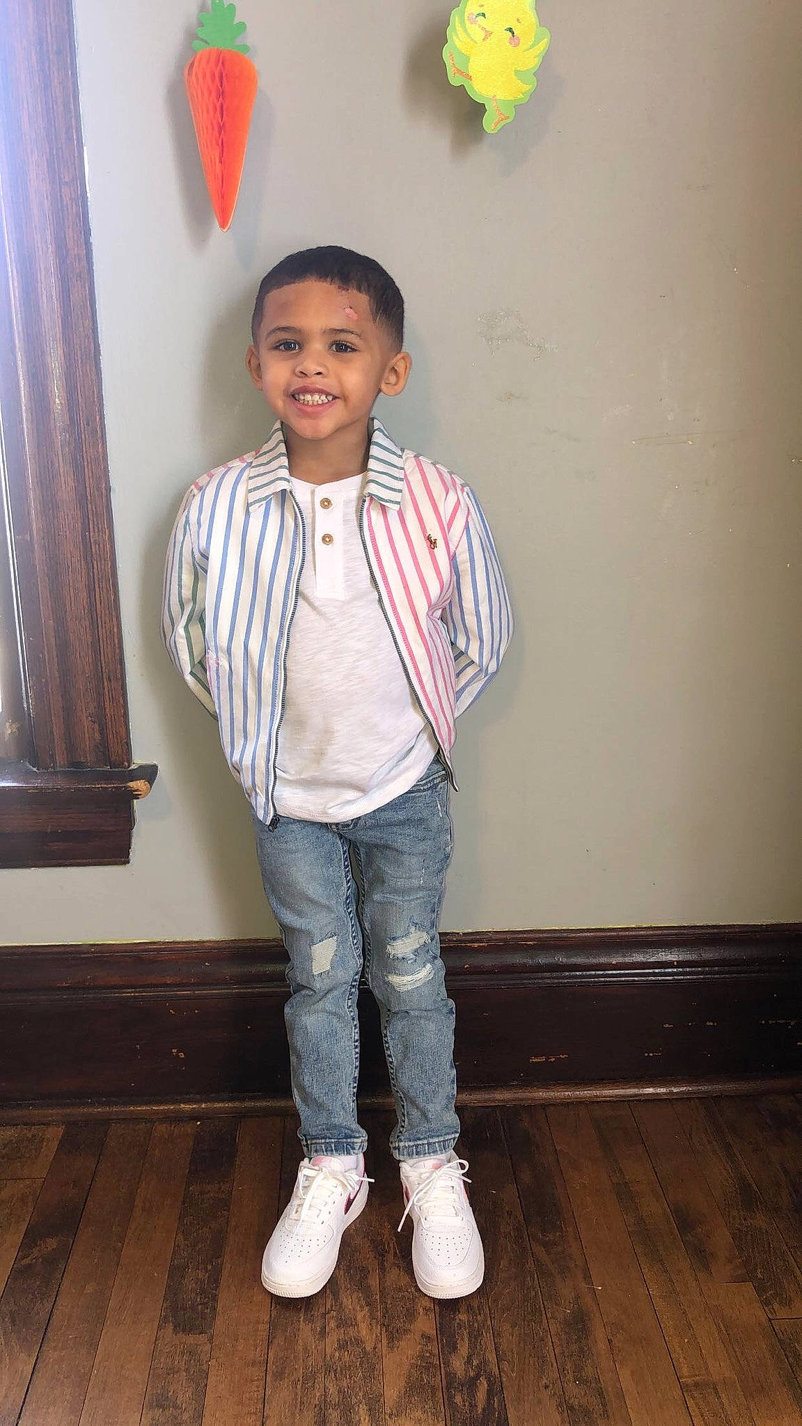 Kyaire is registered to the contest to win money with this photo: child, curtain, denim, dress_shirt, fashion_design, flooring, formal_wear, hardwood, joy, laminate_flooring, person, room, sleeve, smile, sportswear, t_shirt, toddler, uniform, wood, wood_flooring