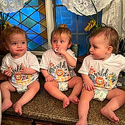 Ryland is registered to the contest to win money with this photo: baby, toddler, child, kitchen, countertop, matching_clothing, diaper, white_shirt, wild_one, indoor, cute, playful, curious, person, family, window, lace_curtains, stained_glass, adult_partial, utensils