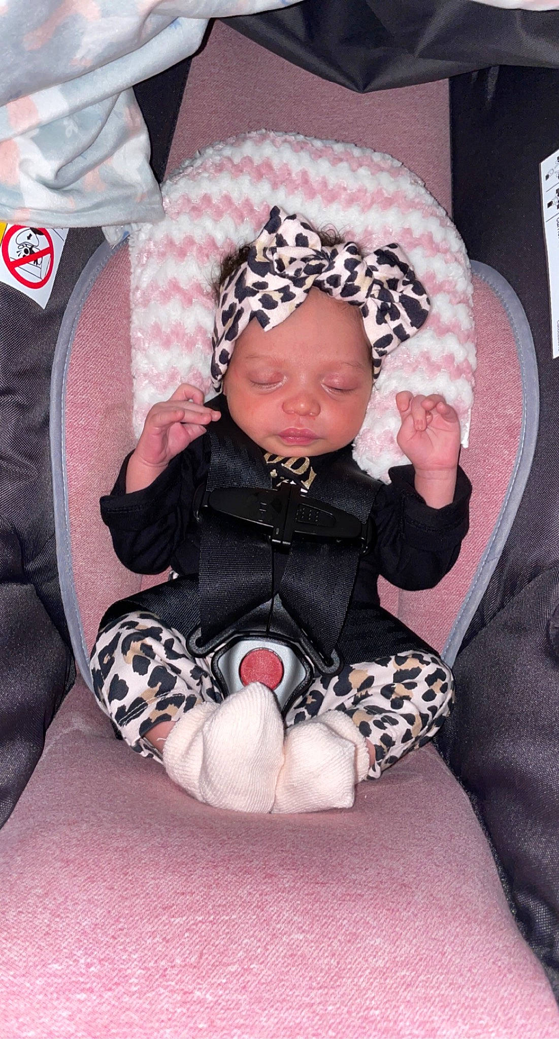 Azariyah joined the competition — help win amazing prizes! baby, baby_products, baby_toddler_clothing, beanie, bonnet, car_seat, child, comfort, costume_accessory, headband, headwear, hood, person, pink, sitting, toddler