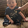 Jeremiah is registered to the contest to win money with this photo: baby, child, couch, pillow, hand, smiling, indoors, clothing, patterned, striped, sitting, face, happy, young, person, home, furniture, sock, cute, portrait