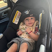 Jeremiah joined the competition — help win amazing prizes! baby, car_seat, hat, bib, child, infant, car_interior, seatbelt, smile, cute, clothing, sitting, window, daylight, person, seat, safety, vehicle, expression, young_child