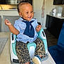 Janelle is registered to the contest to win money with this photo: child, baby, toddler, smiling, sitting, booster_seat, highchair, striped_shirt, navy_scarf, leopard_print_pants, blue_shoes, earrings, kitchen, countertop, dining_table, home_interior, portrait, joyful, hair_bun, cute_expression