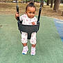 child, toddler, baby, swing, playground, park, trees, sunset, sneakers, floral_outfit, shoes, swing_chains, rubber_surface, green_ground, expression, portrait, outdoors, seat, play, cute
