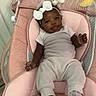 Tylynn is registered to the contest to win money with this photo: baby, infant, smiling, white_clothing, headband, bow, baby_seat, pink_cushion, plush_toys, star_toy, banana_toy, socks, indoors, door, happy, cute, child, person, relaxing, comfortable