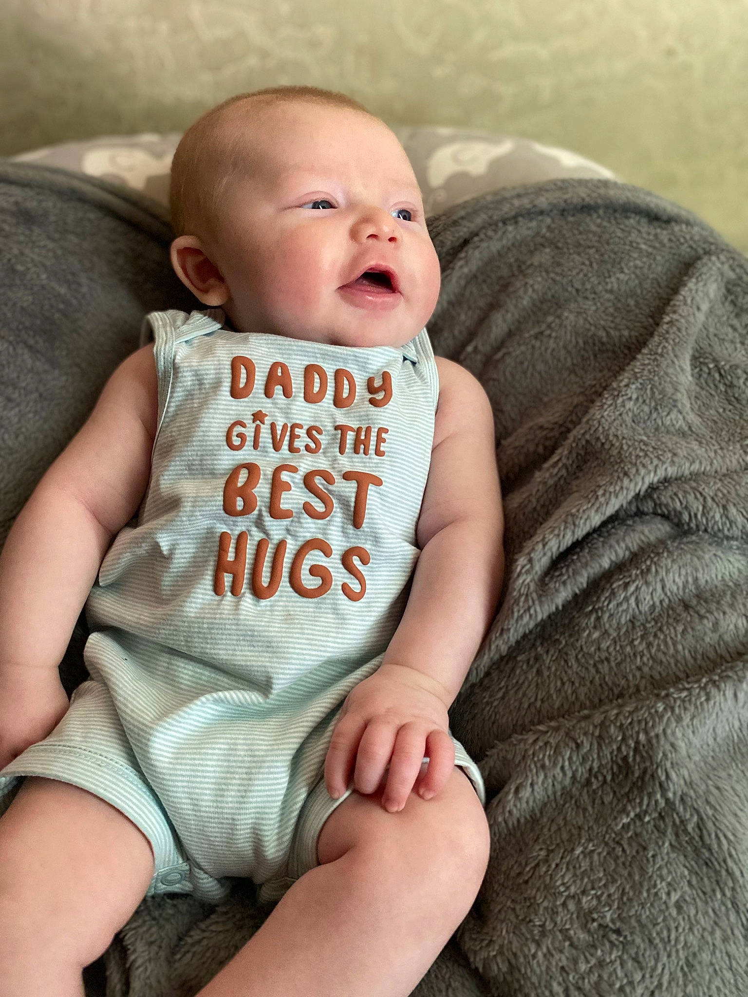 Josiah is registered to the contest to win money with this photo: arm, baby, baby_toddler_clothing, cheek, chin, comfort, eye, face, finger, iris, lip, mammal, mouth, neck, person, skin, sleeve, stomach, t_shirt, textile