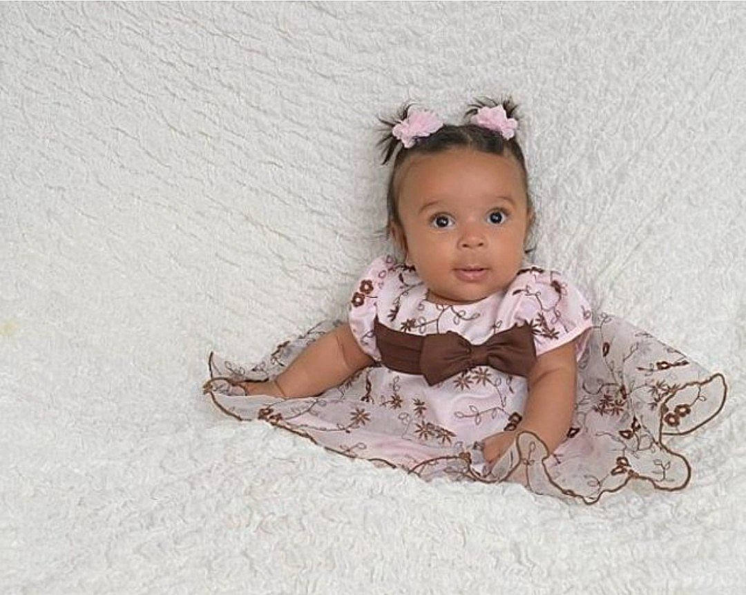 Elena is registered to the contest to win money with this photo: baby, baby_toddler_clothing, child, costume, day_dress, dress, embellishment, eye, eyelash, fashion_accessory, fashion_design, hair_accessory, headband, headpiece, jewellery, pattern, person, sitting, sleeve, toddler