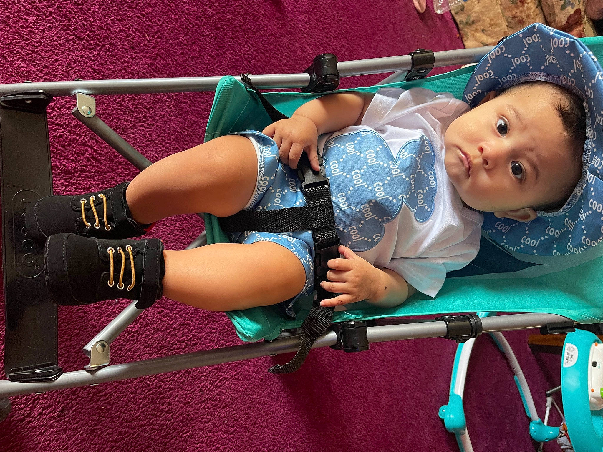 Justin is registered to the contest to win money with this photo: baby, baby_carriage, baby_products, baby_toddler_clothing, drum, electric_blue, fun, grass, human_leg, knee, leisure, magenta, person, product, recreation, shorts, smile, snapshot, thigh, tire