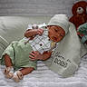newborn, baby, infant, hat, shirt, shorts, socks, blanket, teddy_bear, plush_toy, suspenders, lying_down, cute, cozy, soft_texture, indoor, portrait, sleepy, child, baby_clothes