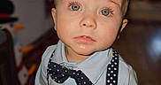 Kohen is registered to the contest to win money with this photo: bow_tie, boy, casual, child, closeup, clothing, curious, cute, expression, eyes, face, fashion, indoor, person, portrait, shirt, standing, suspenders, toddler, young_child