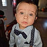 bow_tie, boy, casual, child, closeup, clothing, curious, cute, expression, eyes, face, fashion, indoor, person, portrait, shirt, standing, suspenders, toddler, young_child