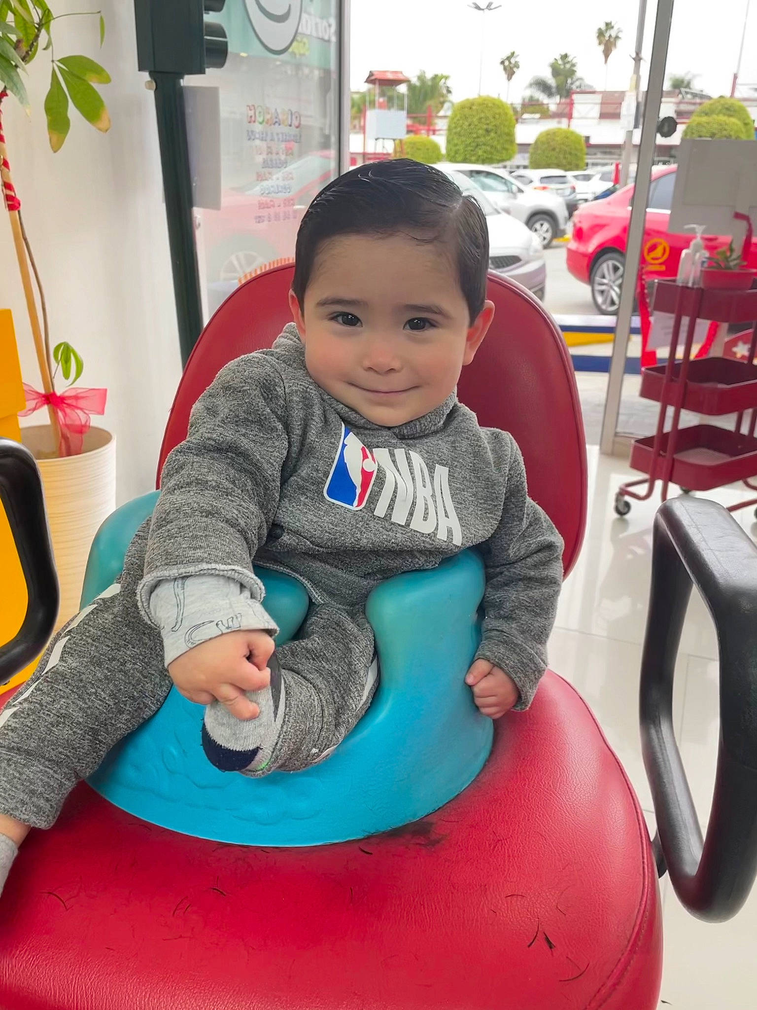 Nico is registered to the contest to win money with this photo: baby, baby_playing_with_toys, baby_toddler_clothing, car, chair, child, eye, fun, happy, houseplant, joy, leisure, person, plant, recreation, riding_toy, sitting, smile, standing, tire