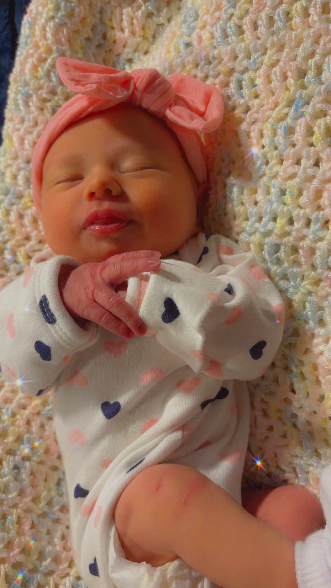 Harper is registered to the contest to win money with this photo: baby, sleeping, headband, bow, onesie, heart_pattern, blanket, knitted, pastel_colors, soft_texture, infant, peaceful, cute, hand, foot, cozy, indoors, portrait, newborn, sparkle_effect