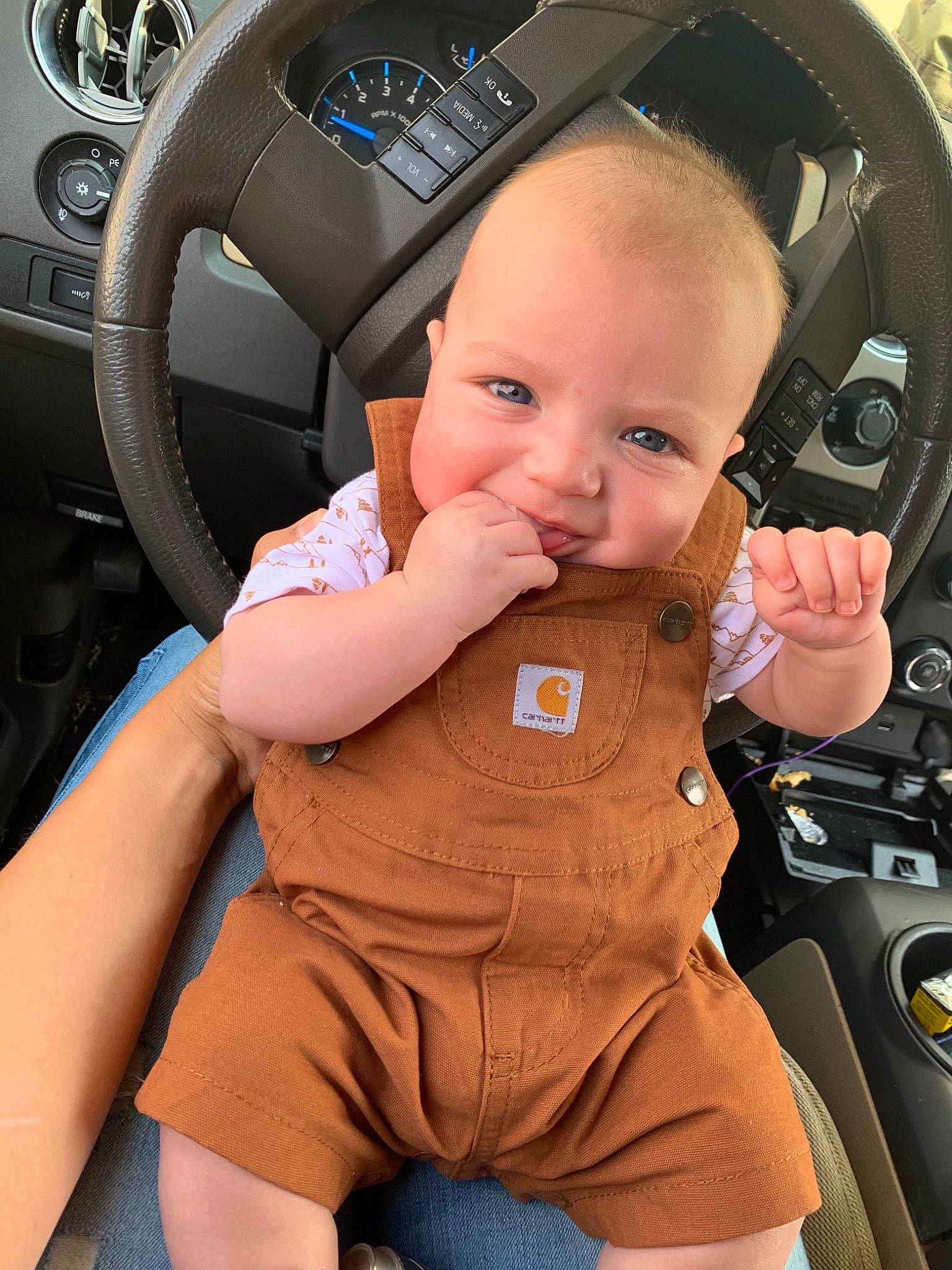 Haiden is registered to the contest to win money with this photo: auto_part, baby, baby_in_car_seat, car_seat, child, person, steering_part, steering_wheel, toddler