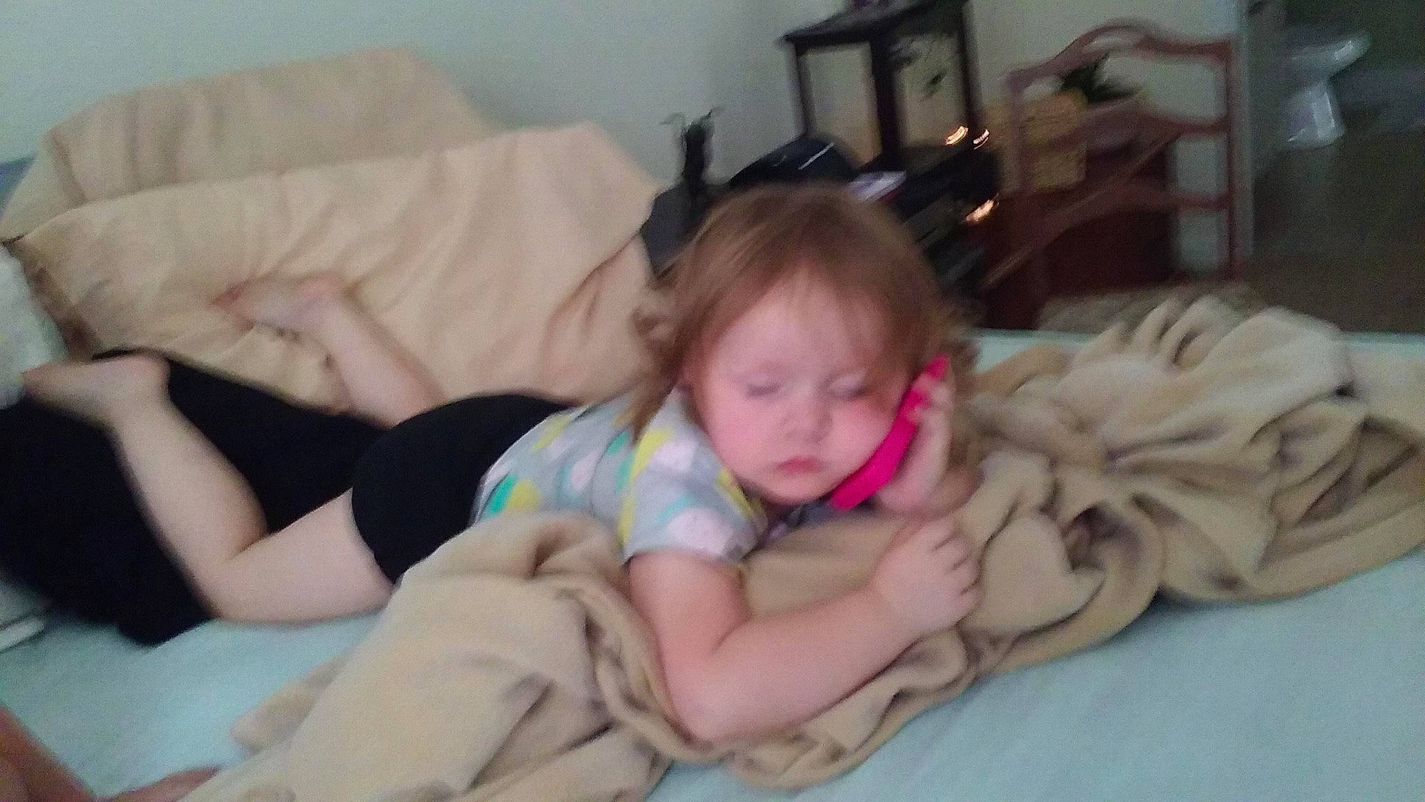 Harmony is registered to the contest to win money with this photo: baby, baby_toddler_clothing, bed, bedding, bedtime, cheek, child, comfort, fun, gesture, happy, human_leg, lap, linens, nap, person, picture_frame, room, sitting, thigh