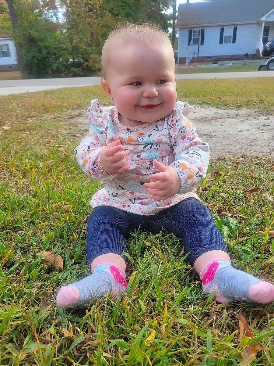 Ava joined the competition — help win amazing prizes! baby, baby_toddler_clothing, child, finger, fun, grass, grassland, happy, human_leg, joy, lawn, people_in_nature, person, pink, plant, skin, smile, spring, toddler, tree