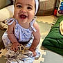 baby, child, smiling, headband, bow, toy, turtle, play_mat, indoor, happy, sitting, clothing, dress, hand, face, infant, cute, colorful, floor, home