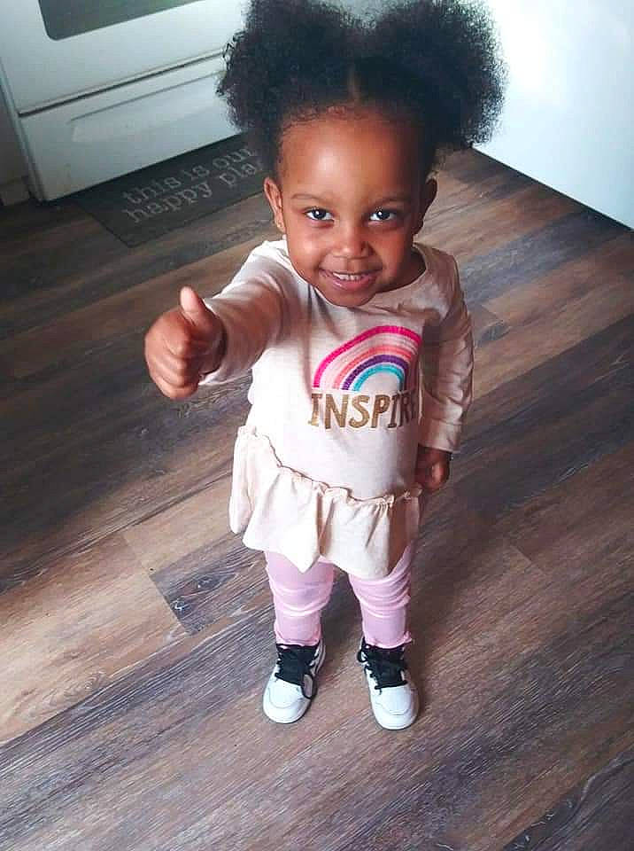Amia is registered to the contest to win money with this photo: afro, baby, baby_toddler_clothing, black_hair, cheek, child, cool, floor, hair, hairstyle, head, human, joy, person, shoe, skin, standing, toddler, toy